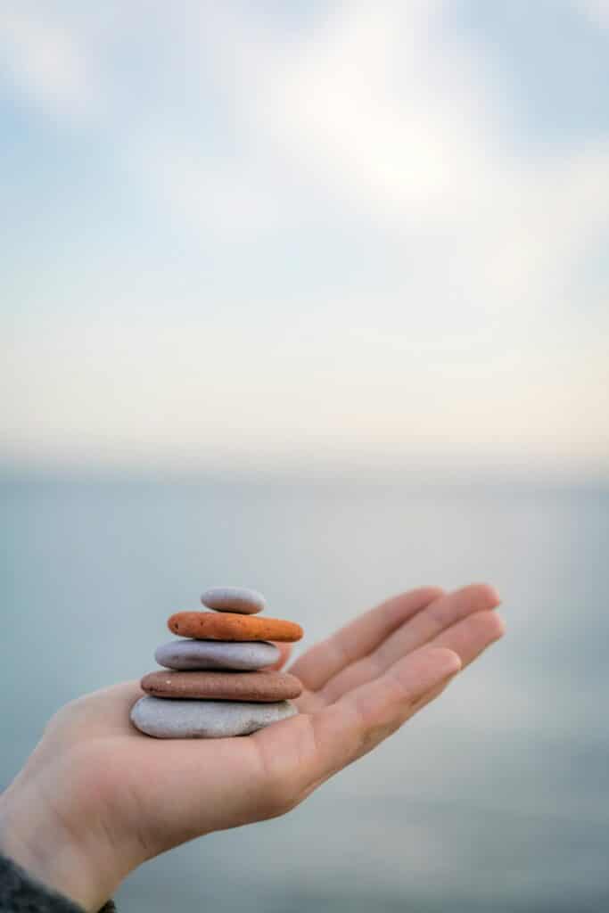 Pile of stacked stones in human hand